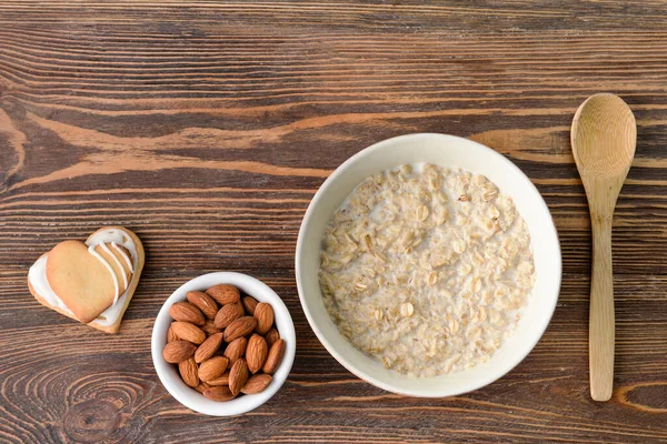 Bowl Tasty Oatmeal Almond Cookies Wooden Background — Stock Photo, Image