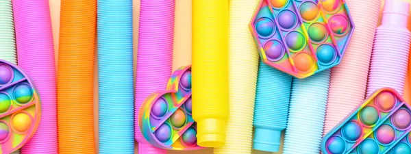 Colorful Pop Tubes Pop Fidget Toys Top View Banner Design — Stock Photo, Image