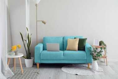 Interior of living room with sofa near light wall