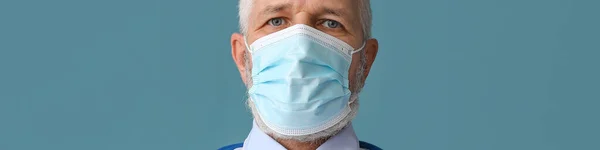 Mature Male Doctor Medical Mask Blue Background — Stockfoto