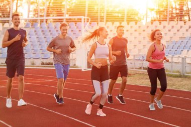 Stadyumda koşan sportif gençler