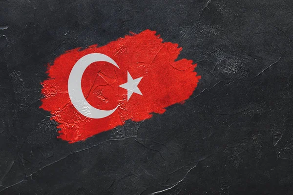 Flag of Turkey painted on dark grunge background