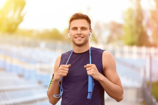 Sporty Young Man Skipping Rope Earphones Stadium — Stock Photo, Image