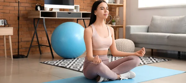Sporty Young Woman Lotus Position Meditating Home — Stockfoto