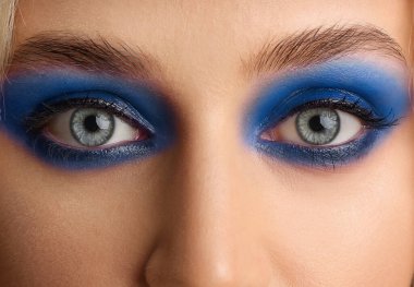 Young woman with beautiful blue eyeshadows, closeup