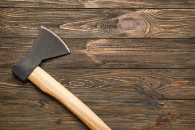 Sharp ax on wooden background
