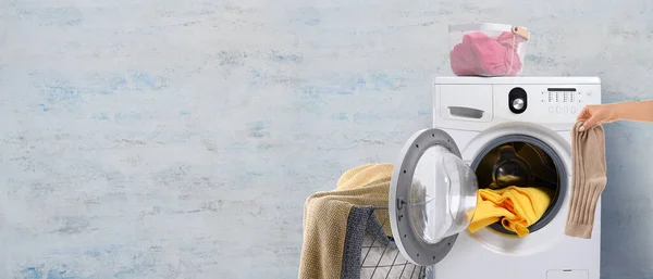 Hand Putting Socks Washing Machine Light Color Background Banner Design — Stok fotoğraf