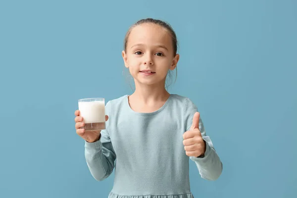 Little Girl Holding Glass Milk Showing Thumb Blue Background — Zdjęcie stockowe