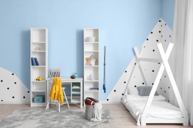 Interior of children's room with modern furniture and rugby balls
