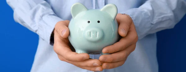 Man Piggy Bank Blue Background Closeup — Stock Photo, Image