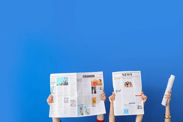 People Holding Newspapers Blue Background — 스톡 사진