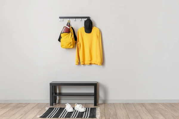 Rugby Ball Backpack Clothes Hanger Shoes Light Wall — 图库照片