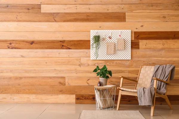 Stylish Armchair Pegboard Table Houseplant Wooden Wall Room — Stok fotoğraf