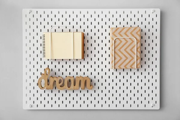 Pegboard Notebooks Word Dream Grey Wall — Fotografia de Stock