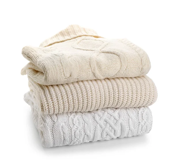 Beyaz arkaplanda sıcak süveter yığını