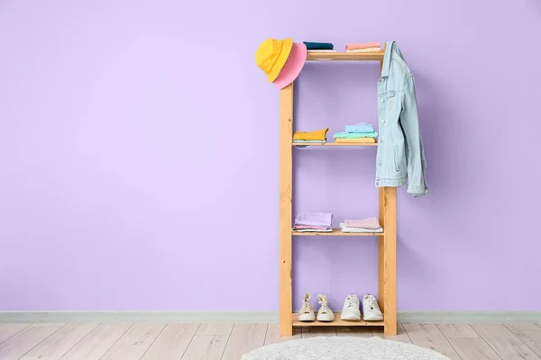 Wooden Shelf Unit Stylish Clothes Shoes Violet Wall Room Interior — Stock Photo, Image