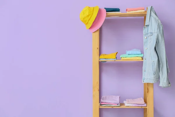 Wooden Shelf Unit Stylish Clothes Violet Wall — Stock Photo, Image