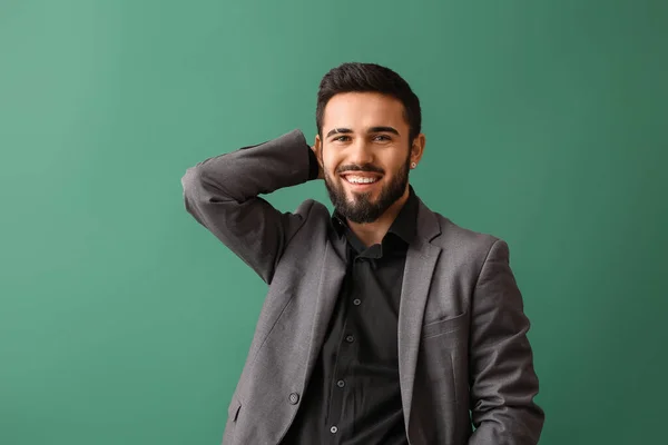 Fashionable Bearded Man Keeping Hand Head Green Background — Stockfoto