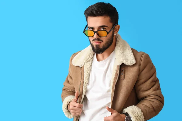 Fashionable Bearded Man Winter Jacket Sunglasses Blue Background — Stok Foto