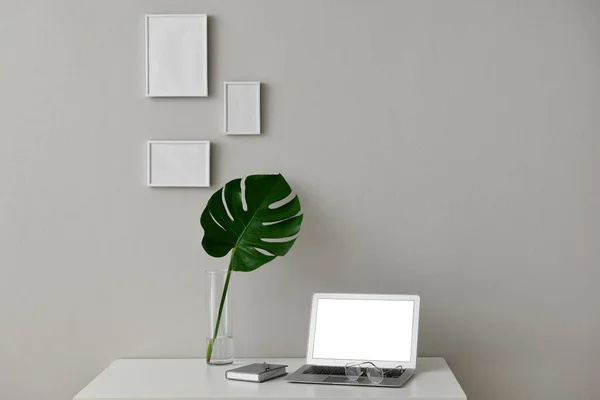 Modern Workplace Laptop Blank Photo Frames Vase Tropical Leaf Light — Photo
