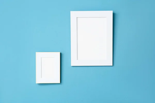 Blank Photo Frames Hanging Blue Wall —  Fotos de Stock