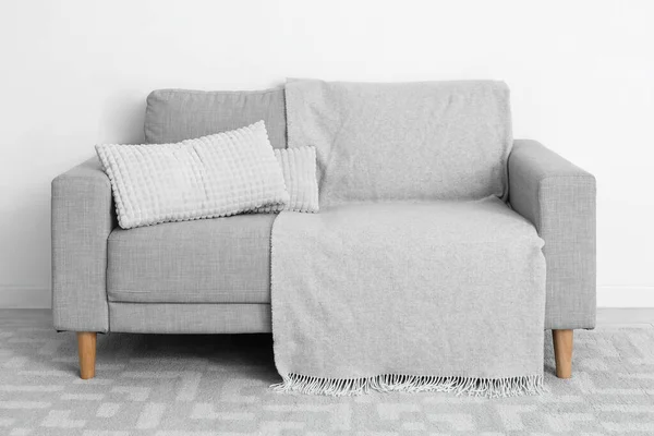 Grey Sofa Pillows Plaid Light Wall — Zdjęcie stockowe