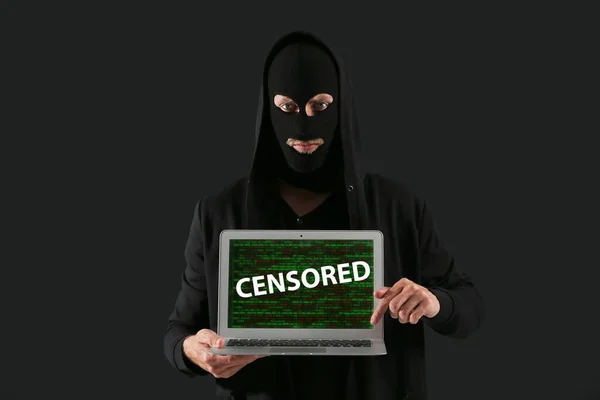 Male Hacker Holding Laptop Word Censored Screen Dark Background — Stockfoto