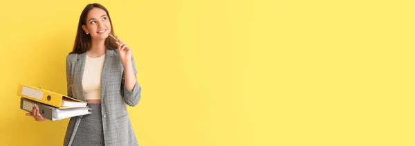 Thoughtful Young Woman Holding Folders Yellow Background Space Text — Stock Photo, Image