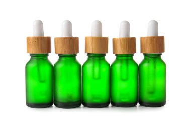 Beyaz arka planda bir sürü serum şişesi