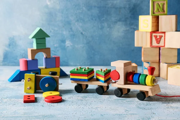 Toy train with building blocks on blue background