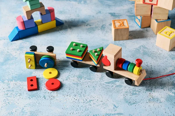 Toy train with building blocks on blue background