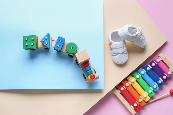 Baby Booties Toy Train Xylophone Color Background — Stock Photo, Image