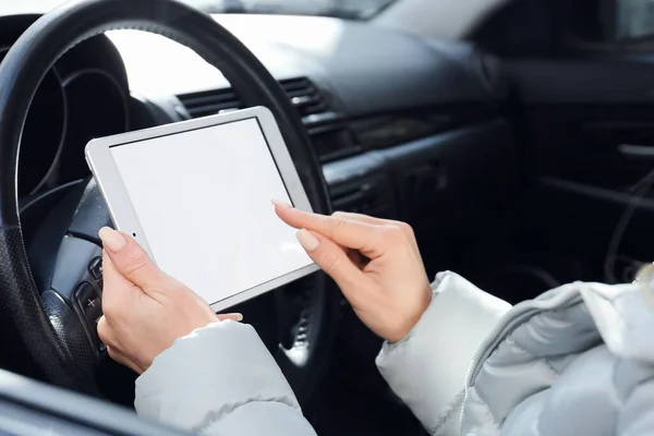 Female driver using tablet computer for navigation, closeup