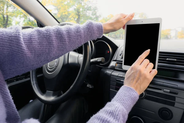 Female driver using tablet computer for navigation