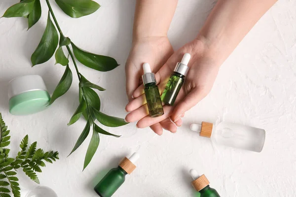 Female Hands Bottles Natural Serum Cosmetics Plant Branch Light Background — Stock Photo, Image