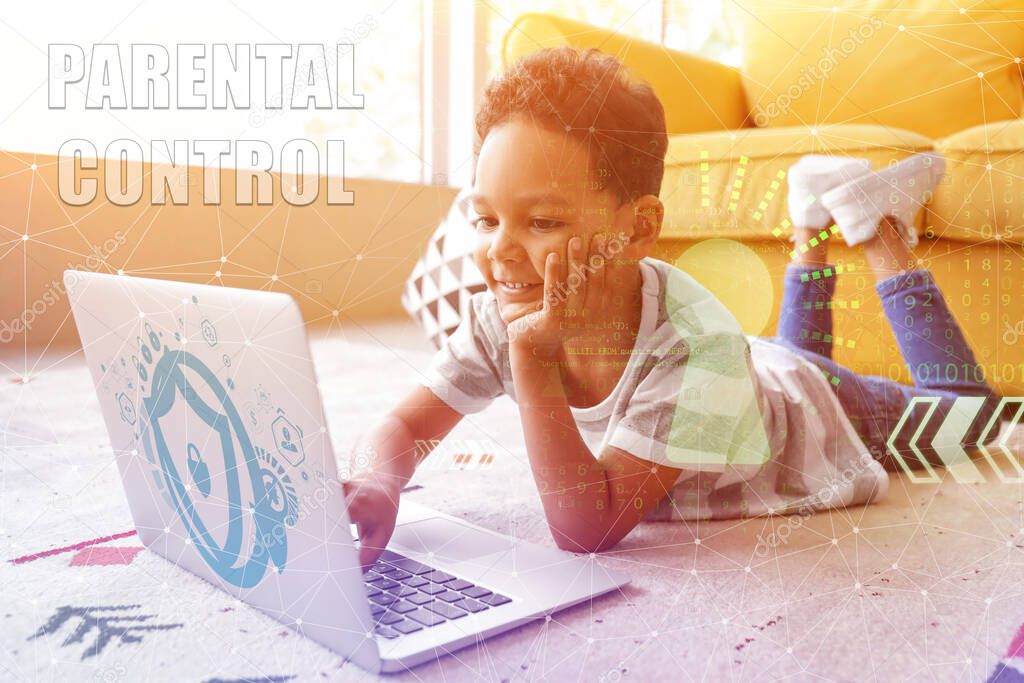 Little African-American boy with laptop at home. Concept of parental control