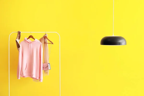 Rack Pink Hoodie Heels Scarf Bag Lamp Hanging Yellow Wall — Stock Photo, Image