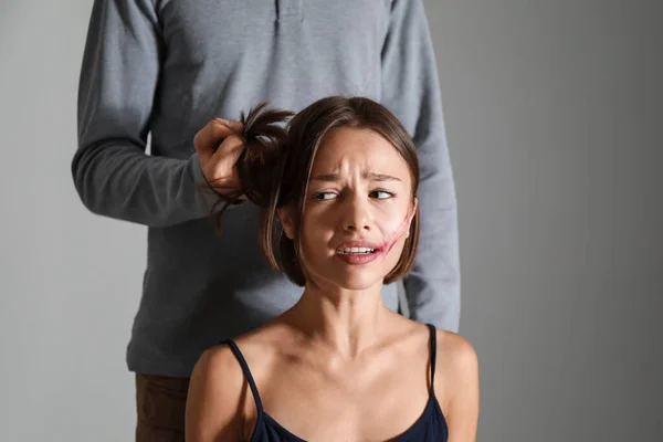 Scared Woman Her Abuser Grey Background Violence Concept — Stock Photo, Image