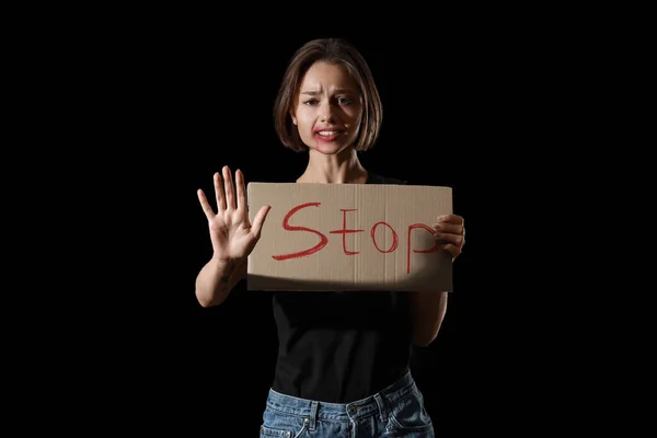 Bruised Young Woman Holding Cardboard Word Stop Black Background Violence — Stock Photo, Image