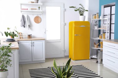 Mutfağın içindeki sarı renkli buzdolabı.