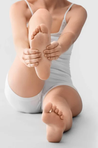 Young Woman Making Foot Massage Light Background Closeup — Stock Photo, Image