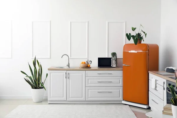 Interior of light modern kitchen with stylish retro refrigerator