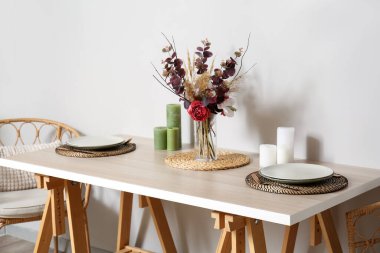 Işık duvarının yanında güzel bir yemek masası.