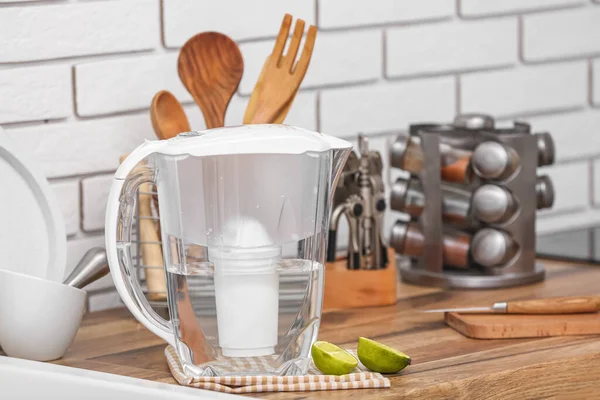 Water filter jug and lime on counter in kitchen