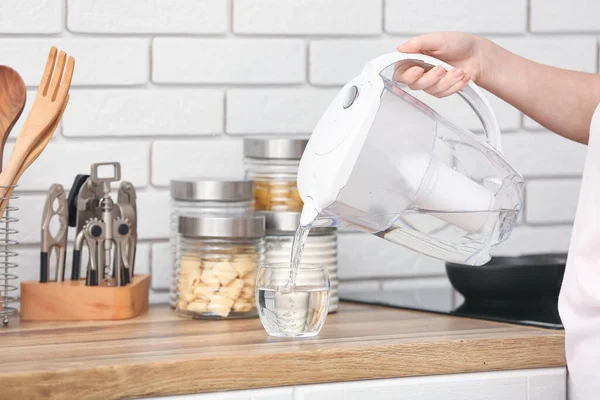 Woman Pouring Purified Water Glass Filter Jug Kitchen — Stock Photo, Image