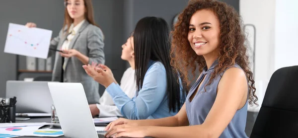 Women discussing issue at business meeting in office