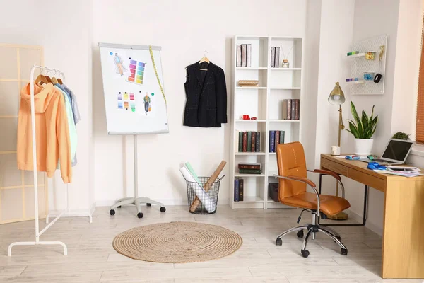 Interior of modern studio with workplace of clothes stylist