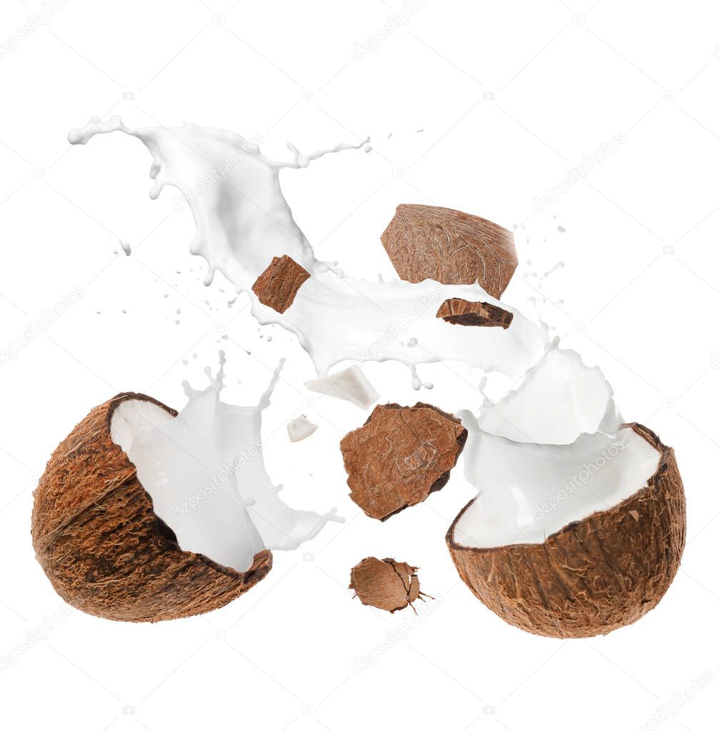 Broken coconut and splash of milk isolated on white