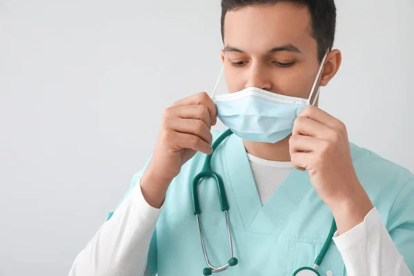 Male Nurse Putting Medical Mask Grey Background — Stock Photo, Image