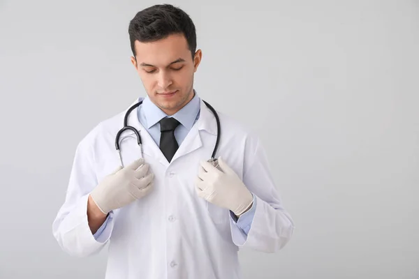 Arzt Mit Stethoskop Auf Grauem Hintergrund — Stockfoto